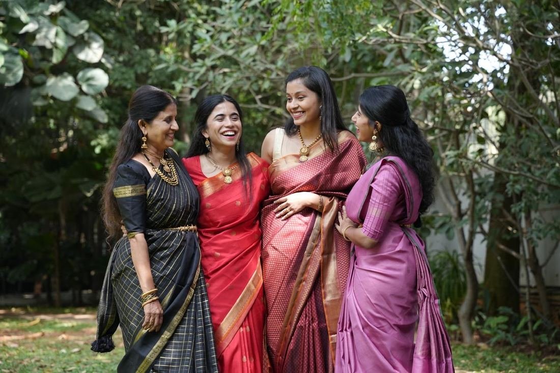 Four women wearing antique gold necklaces